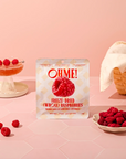 OHME! freeze-dried raspberries packaging on a pink background with raspberries around