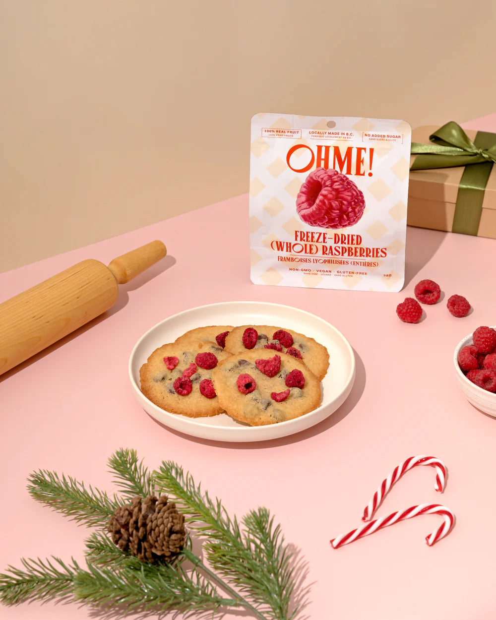 OHME! freeze-dried Raspberries packaging with cookies and raspberries on a pink surface