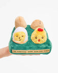 A plush dog toy resembling two stylized eggs with faces, in green fabric, with a squeaker inside. the furry folks farm aaa+ fun 4 eggs